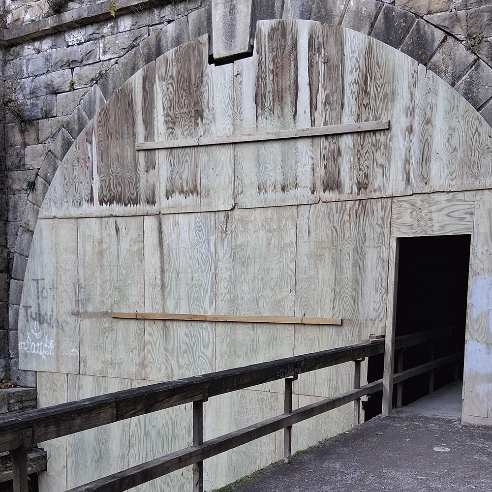 tunnel entrance boarded with plywood